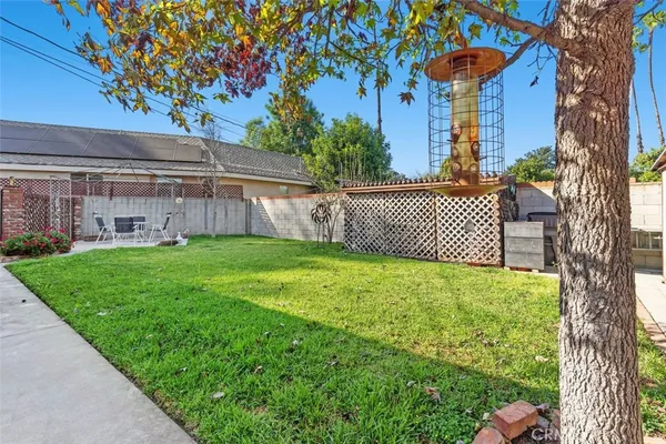 a view of a house with backyard and sitting area