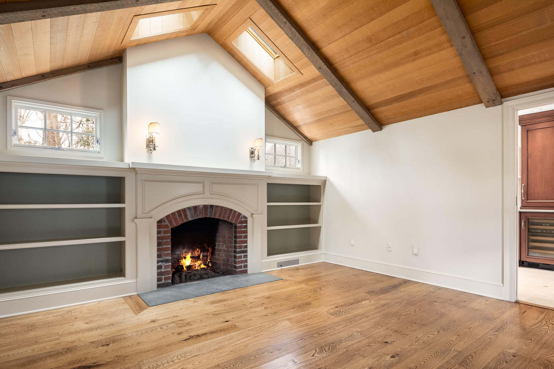 840 Hollow Tree Ridge Road Darien, CT 06820 - Photo 16 of 27 a view of an empty room with wooden floor fireplace and a window
