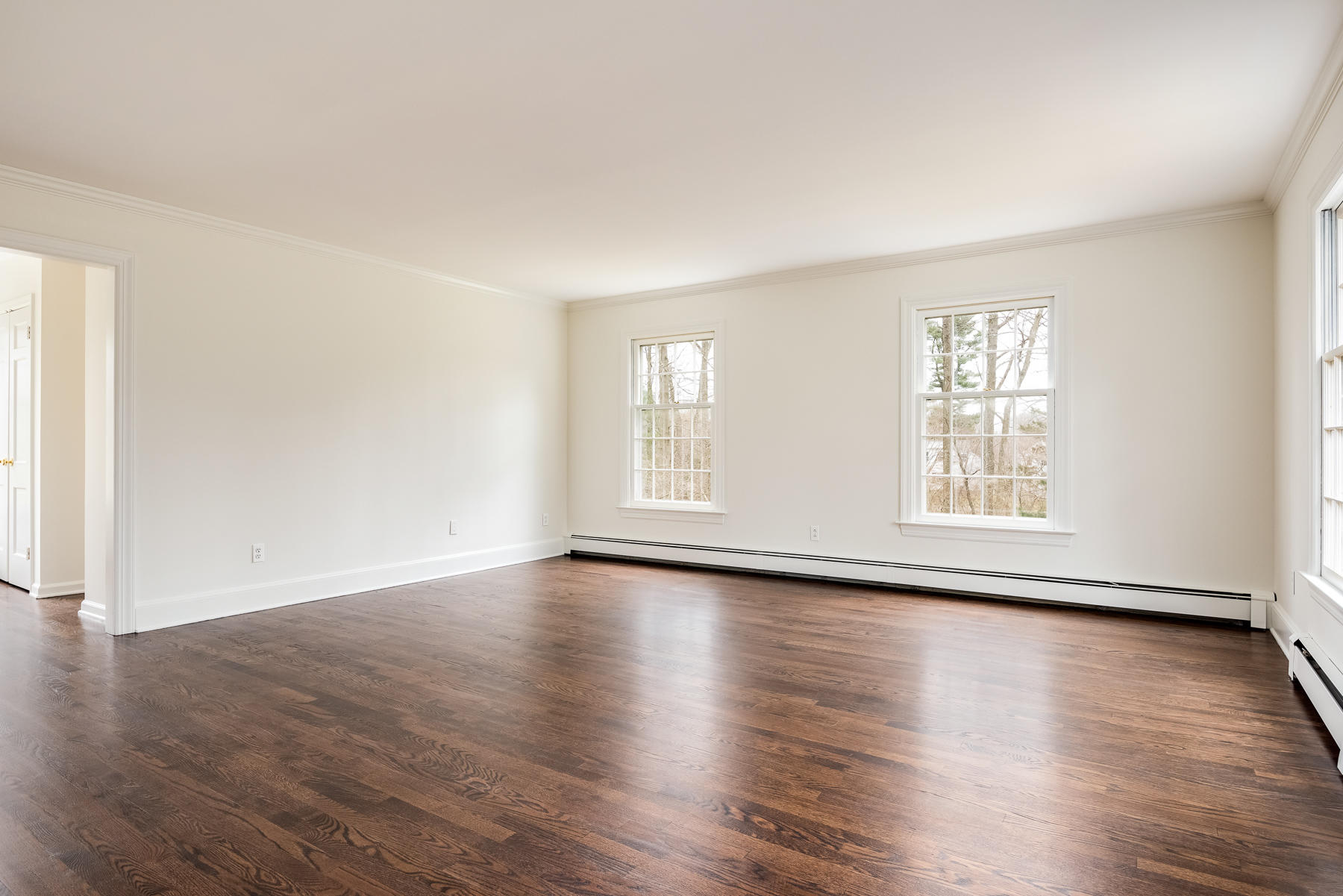 840 Hollow Tree Ridge Road Darien, CT 06820 - Photo 19 of 27 a view of an empty room with wooden floor and window