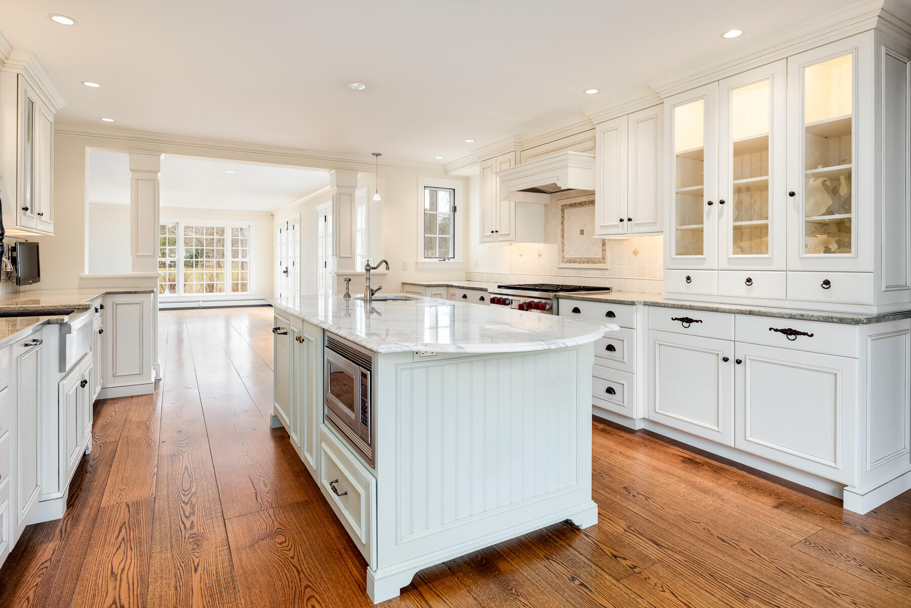 840 Hollow Tree Ridge Road Darien, CT 06820 - Photo 8 of 27 a kitchen with stainless steel appliances granite countertop wooden floors and white cabinets