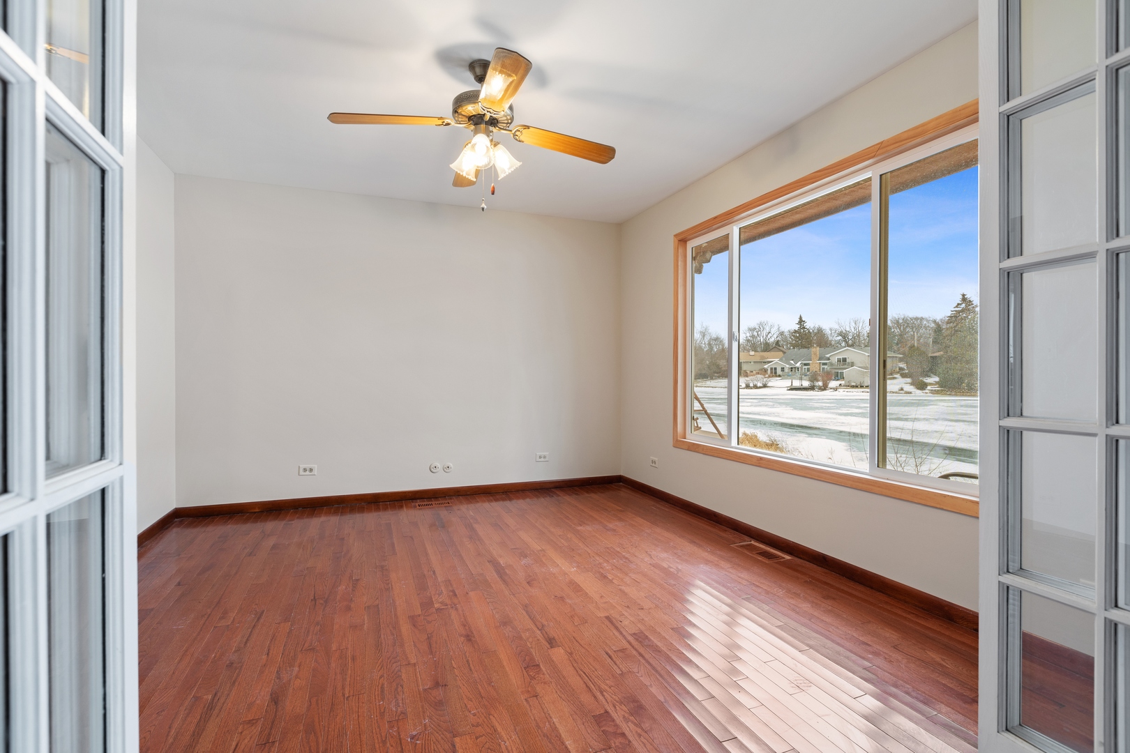 378 Northgate Road Lindenhurst, IL 60046 - Photo 9 of 26 a view of an empty room with wooden floor and a window