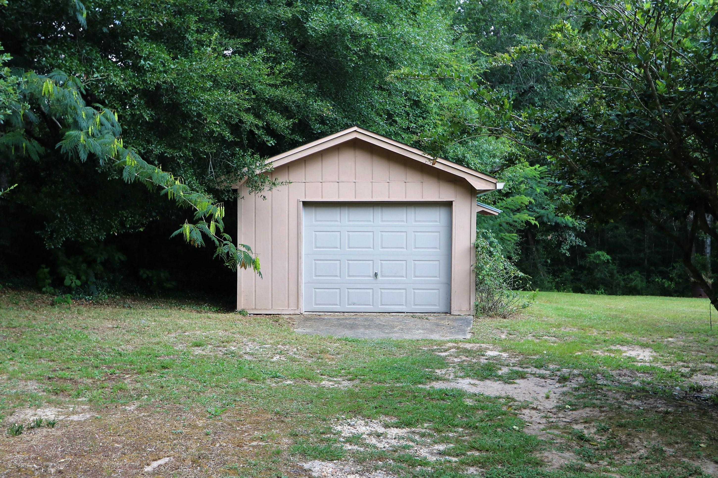 3097 Bay Ridge Drive Crestview, FL 32539 - Photo 18 of 21 a view of a house with a yard and large trees