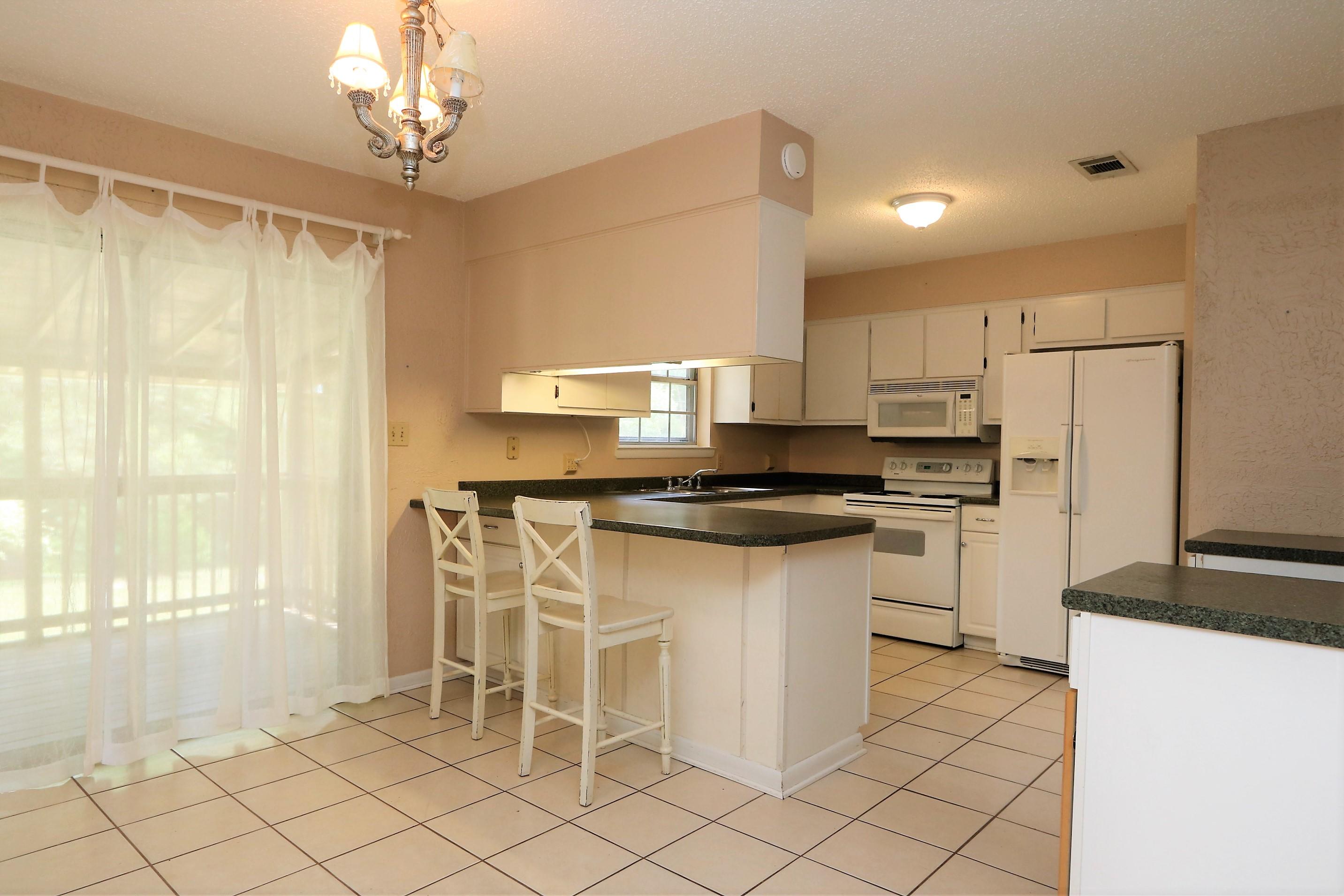 3097 Bay Ridge Drive Crestview, FL 32539 - Photo 7 of 21 a kitchen with a refrigerator and a sink