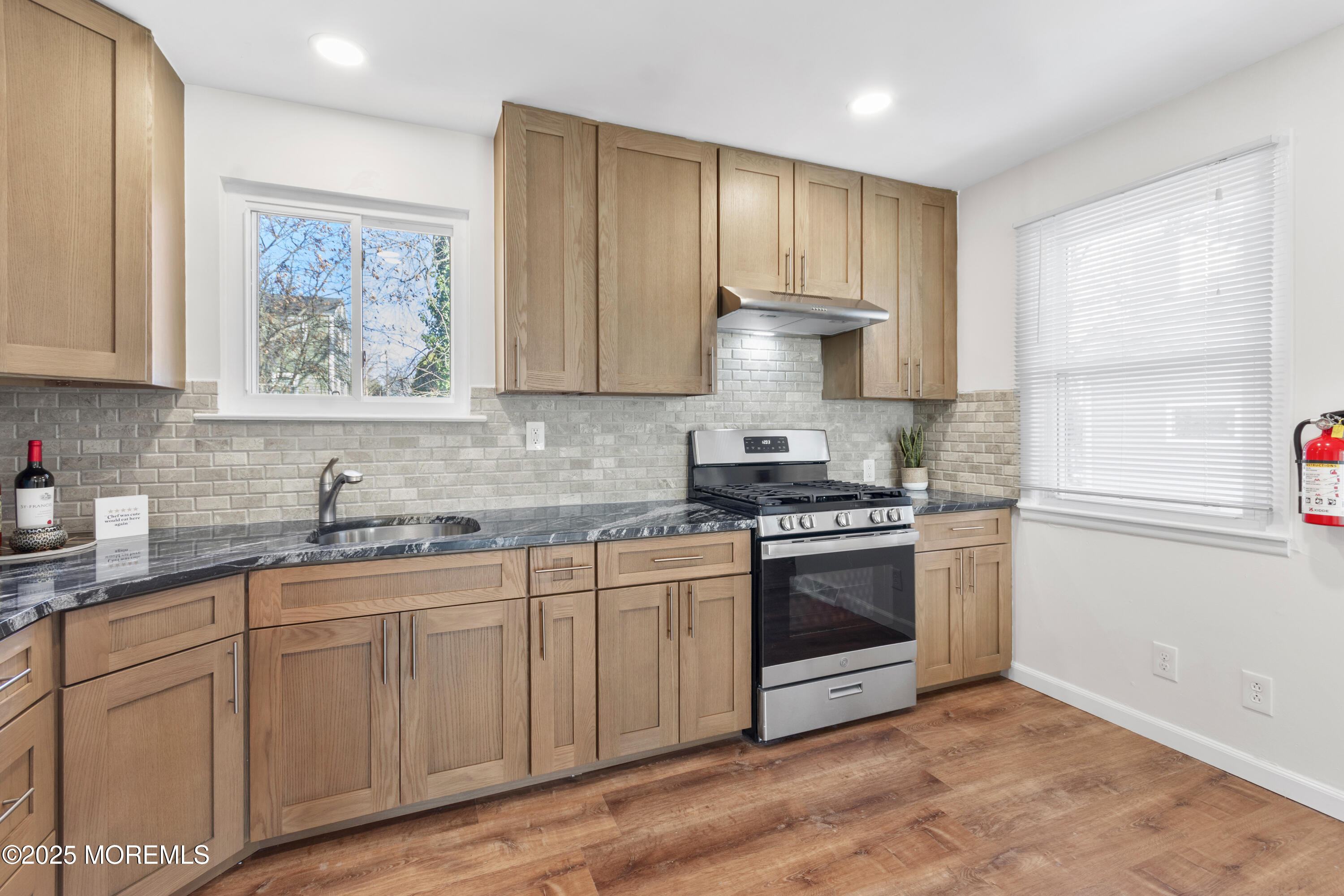 85 Helen Avenue Freehold, NJ 07728 - Photo 4 of 19 a kitchen with stainless steel appliances granite countertop a stove a sink and a refrigerator