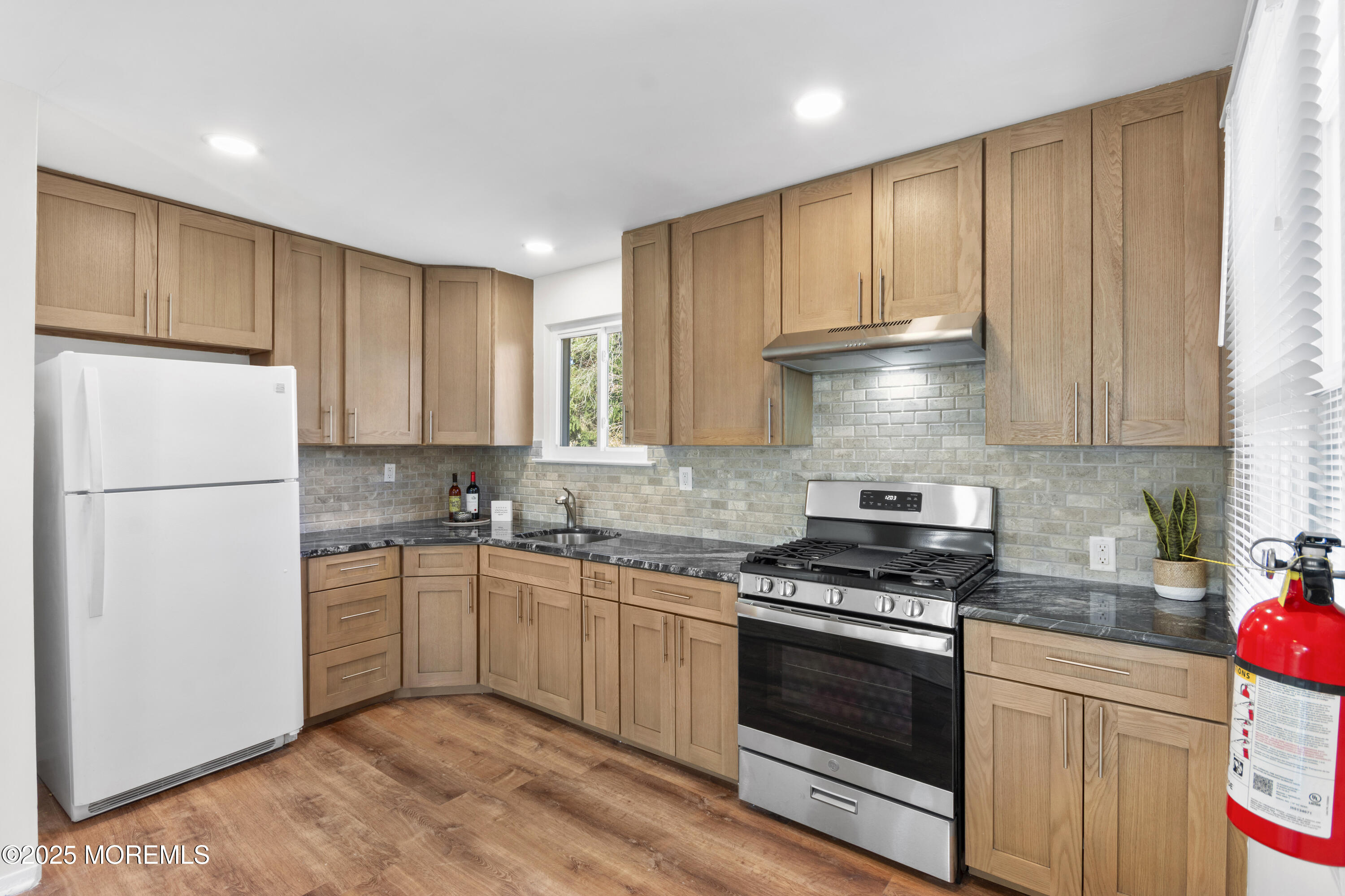 85 Helen Avenue Freehold, NJ 07728 - Photo 5 of 19 a kitchen with granite countertop a sink stainless steel appliances and cabinets