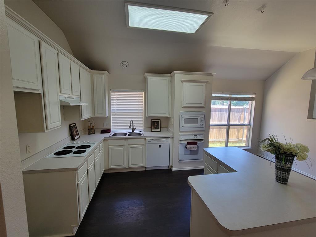 2913 Rush Creek Road McKinney, TX 75072 - Photo 3 of 32 Kitchen with sink, white cabinetry, vaulted ceiling, and white appliances