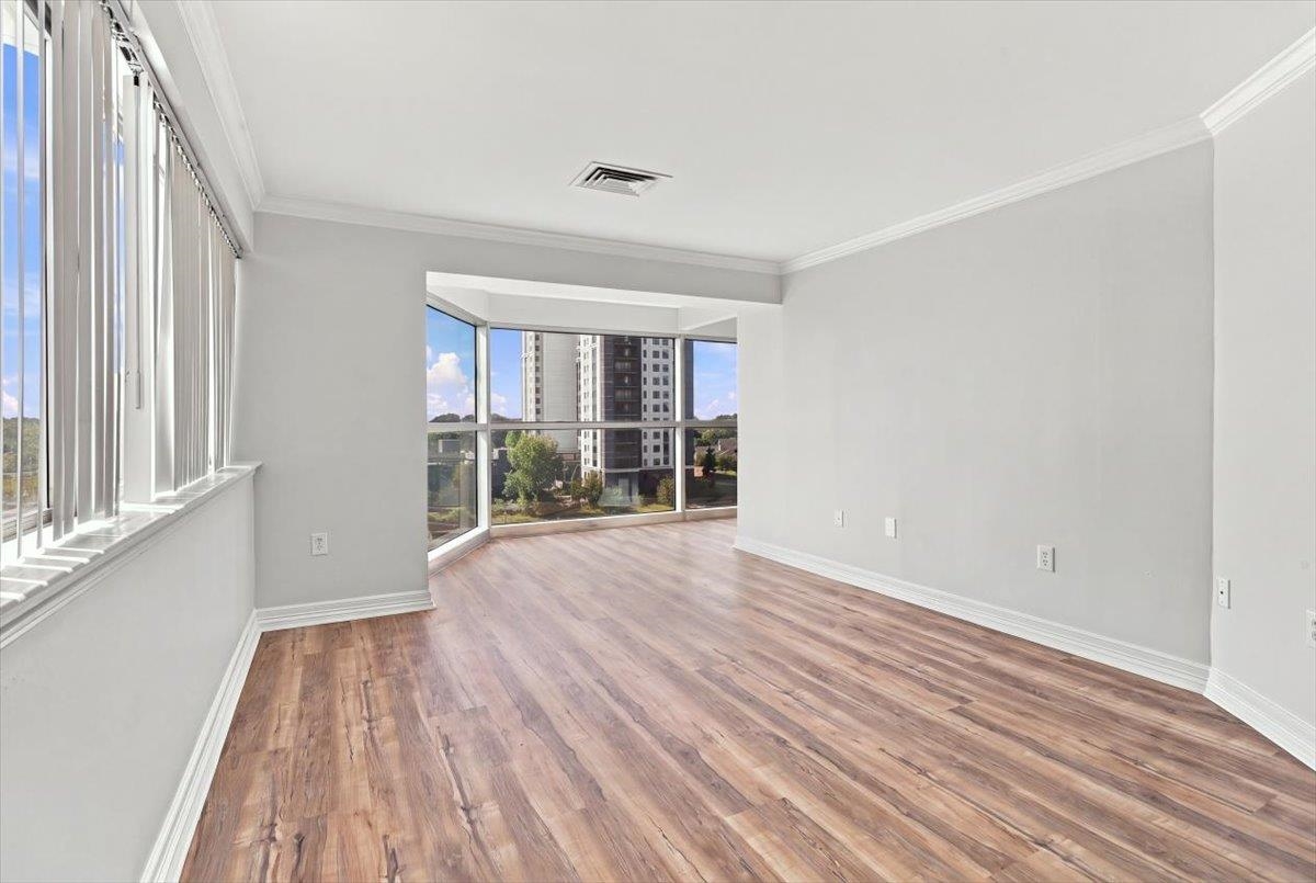 655 Riverside Drive, Unit 608B Memphis, TN 38103 - Photo 15 of 28 Wood-finish flooring, white baseboards, and white crown molding