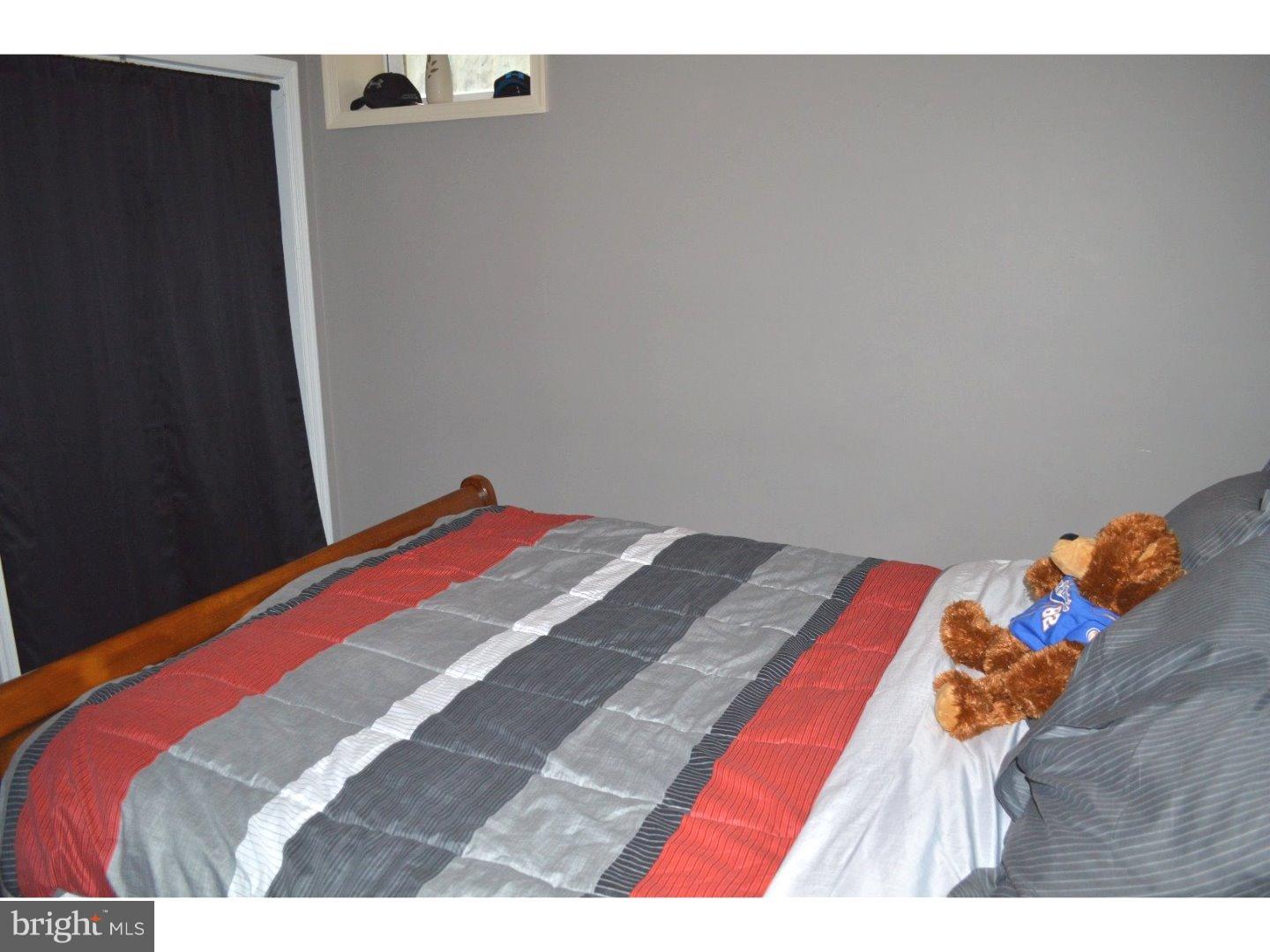 709 Crystle Road Aston, PA 19014 - Photo 11 of 24 a bed sitting in a bedroom next to a window