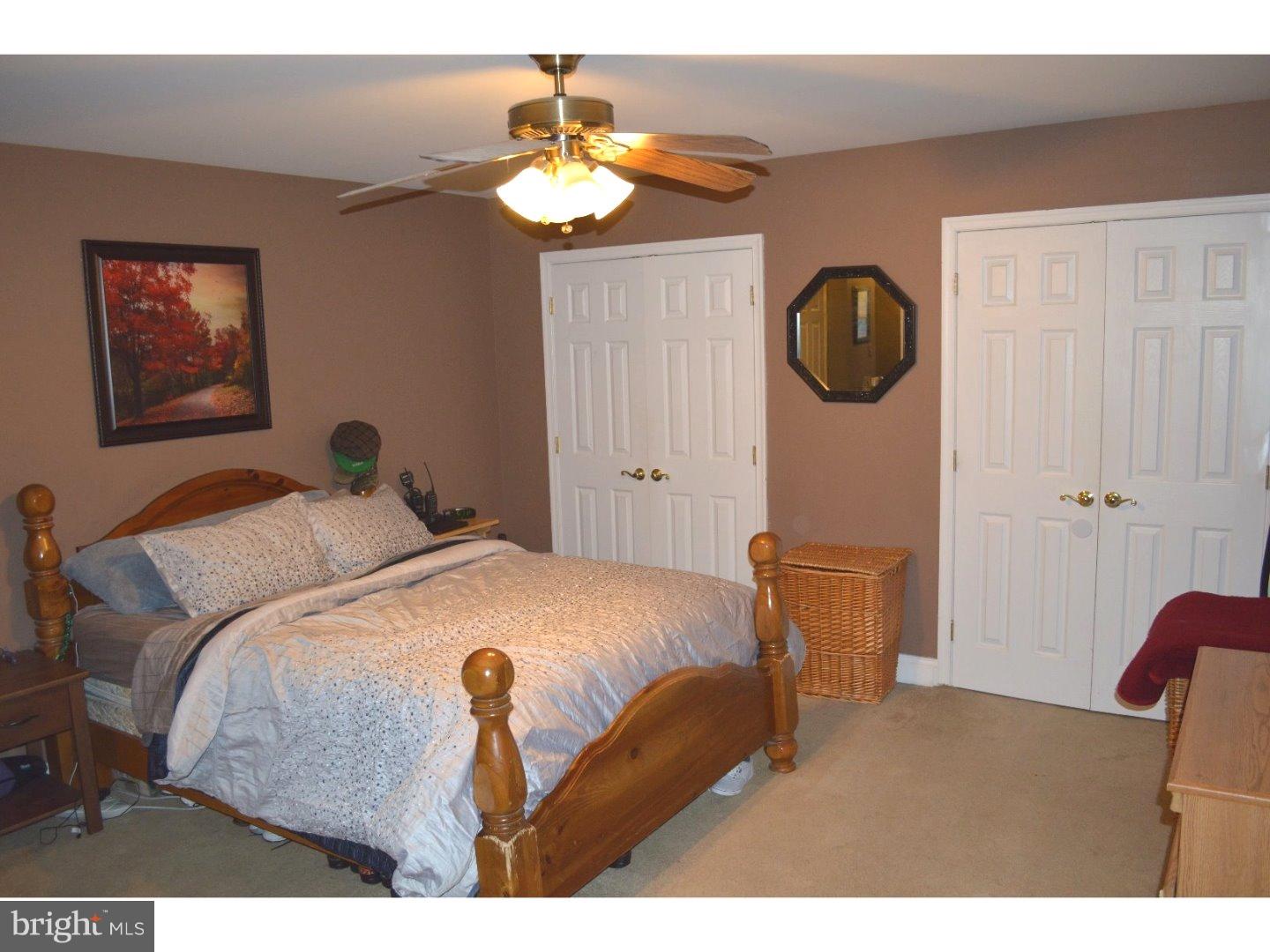709 Crystle Road Aston, PA 19014 - Photo 14 of 24 a bedroom with a bed and a chandelier