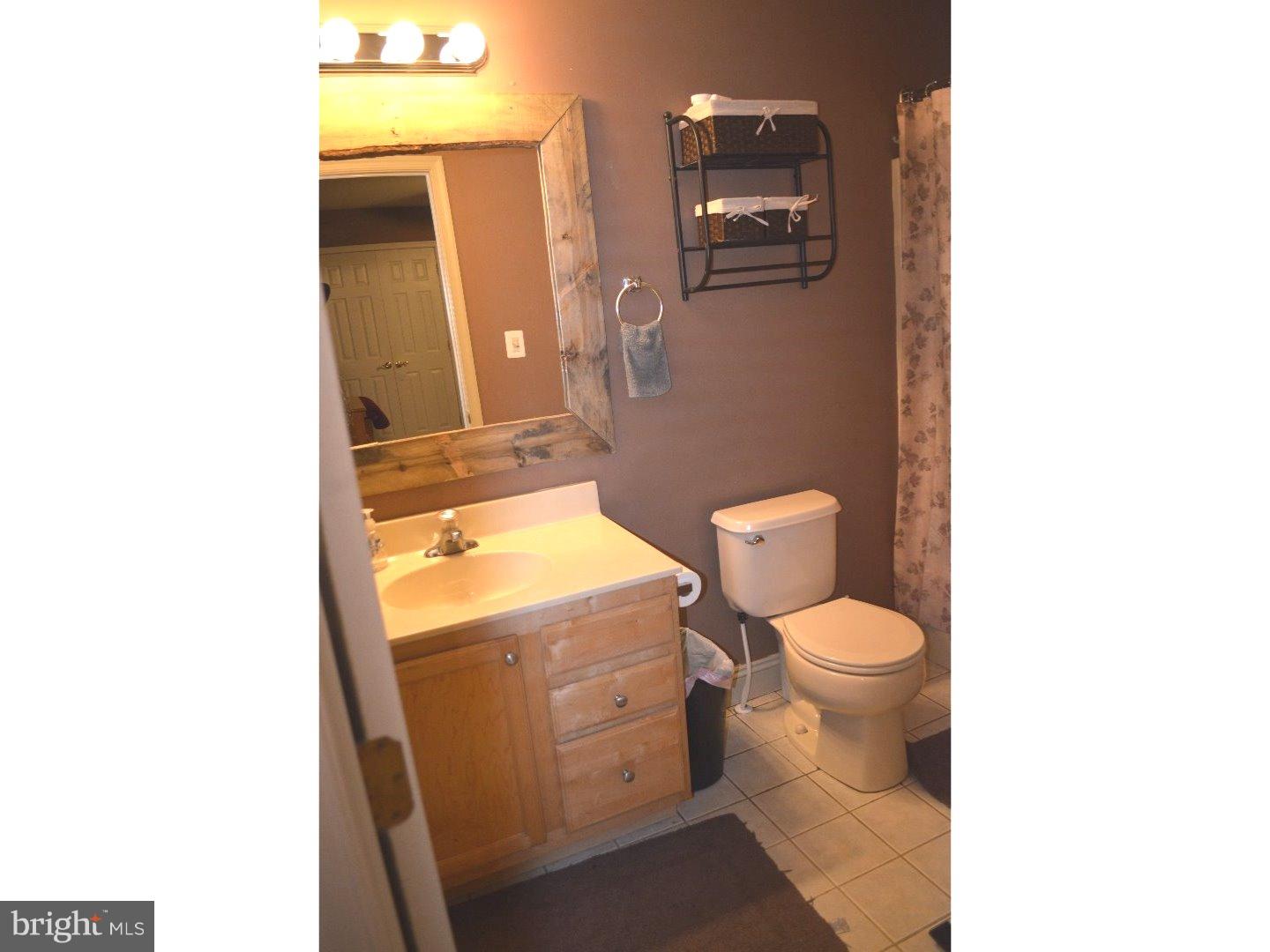 709 Crystle Road Aston, PA 19014 - Photo 16 of 24 a bathroom with a toilet and a mirror