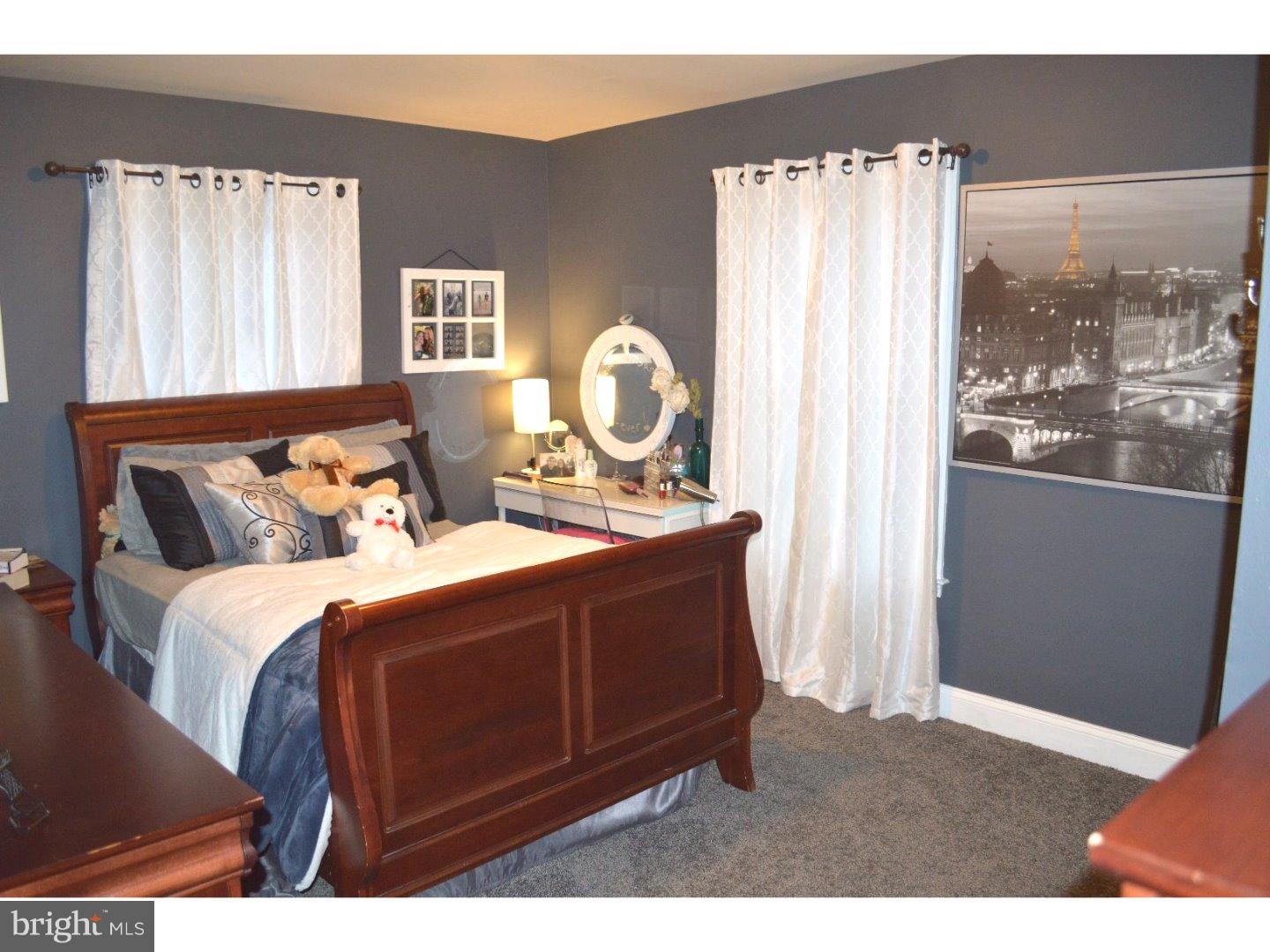 709 Crystle Road Aston, PA 19014 - Photo 17 of 24 a bed sitting in a bedroom next to a window
