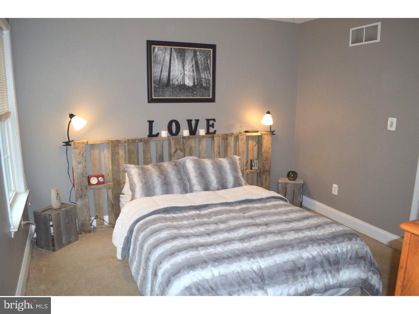 709 Crystle Road Aston, PA 19014 - Photo 20 of 24 a bedroom with a bed and a lamp