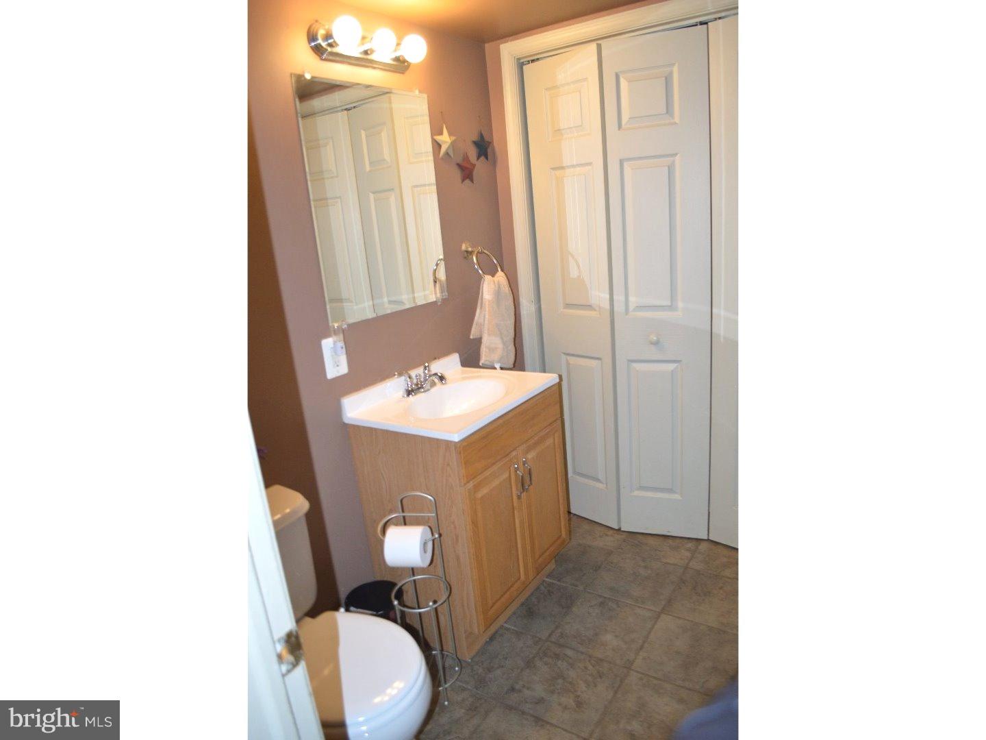 709 Crystle Road Aston, PA 19014 - Photo 4 of 24 a bathroom with a toilet sink and mirror