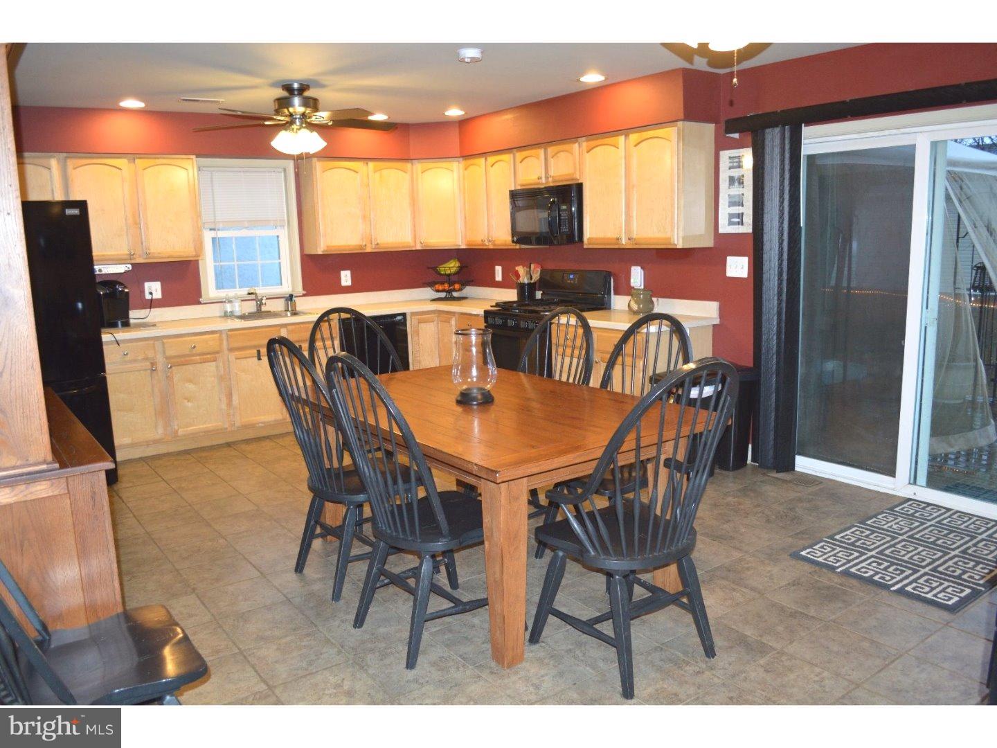 709 Crystle Road Aston, PA 19014 - Photo 6 of 24 a dining room with furniture and a flat screen tv