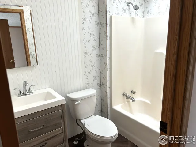 a bathroom with a sink a toilet and shower curtain