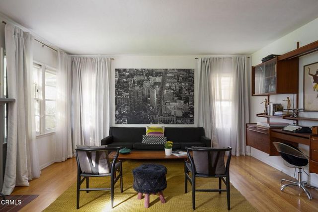 a living room with fireplace furniture and a wooden floor