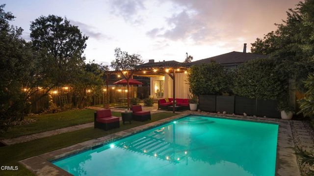 a living room with furniture a fireplace and a large window