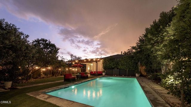 a backyard of a house with table and chairs