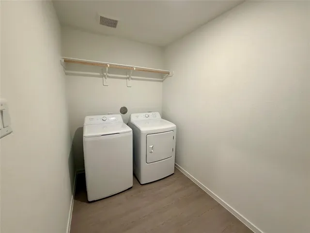a white toilet sitting next to a white sink and vanity
