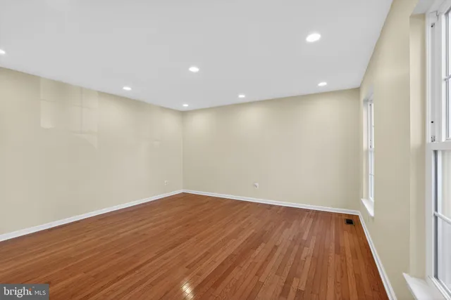a view of room with wooden floor and entrance
