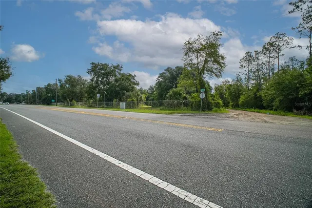 a view of a field with trees