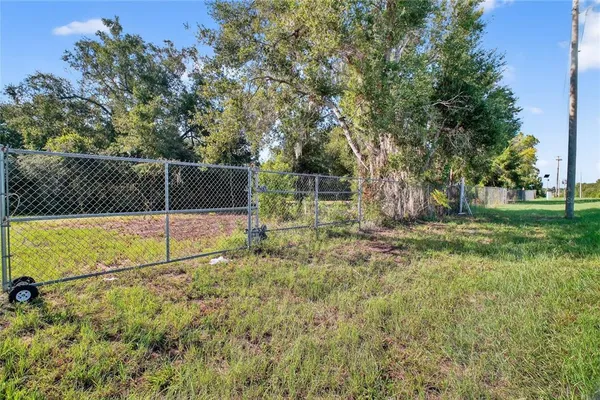 a view of backyard with wooden fence