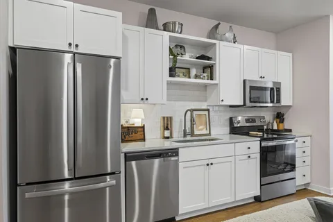 a kitchen with stainless steel appliances a refrigerator sink and cabinets