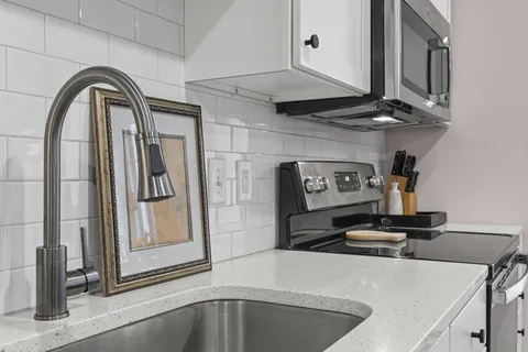 a kitchen with a refrigerator and a stove