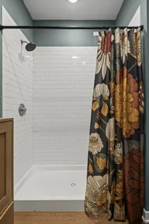 a bathroom with a shower and a bathtub