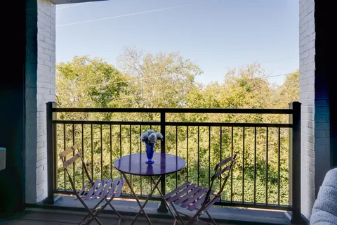 a view of a balcony with furniture