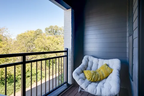 a view of a balcony with wooden floor