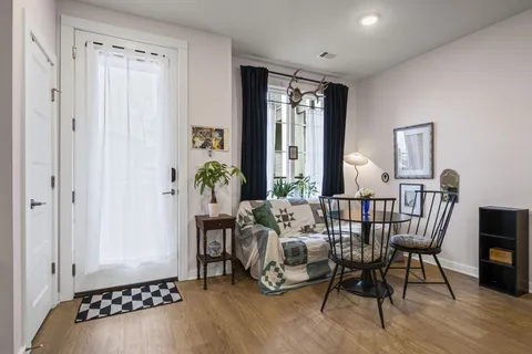a view of a livingroom with furniture and hardwood floor