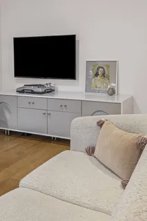 a living room with furniture and a flat screen tv