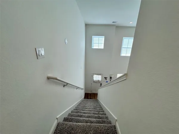 a view of a hallway with stairs