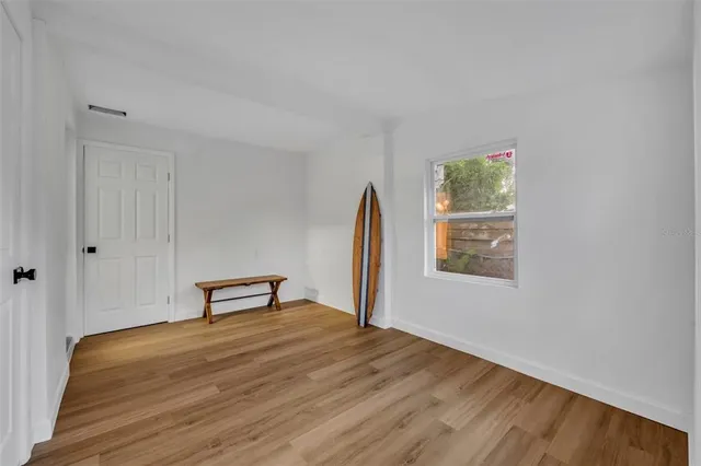 a view of room with window and wooden floor