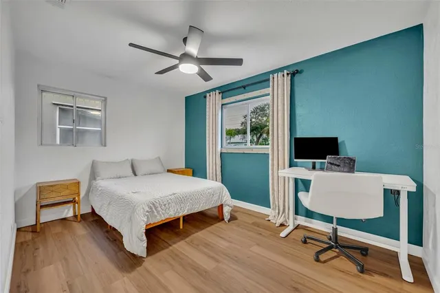 a bedroom with a bed and a desk