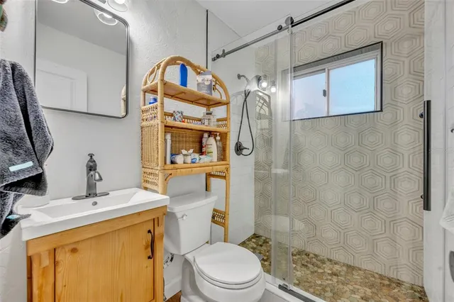 a bathroom with a sink toilet and shower