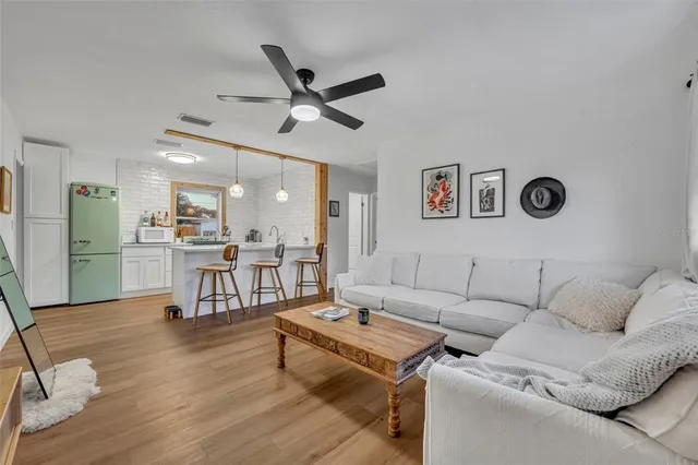 a living room with furniture and kitchen view