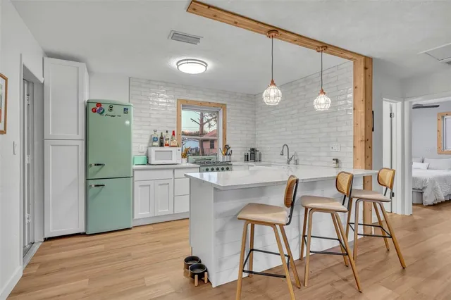 a kitchen with a sink cabinets and refrigerator