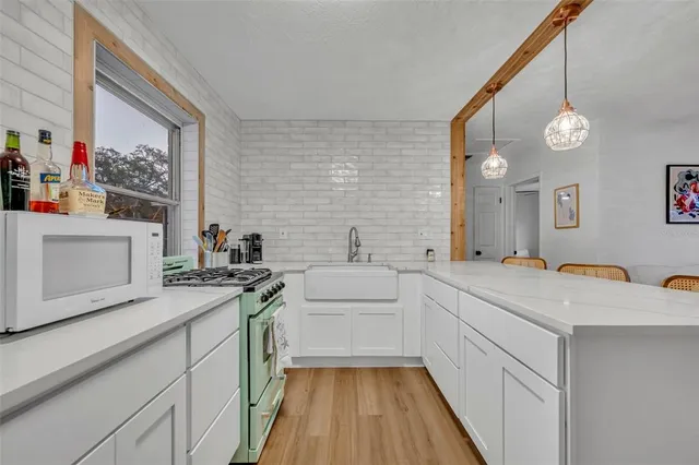 a kitchen that has a sink and a stove in it