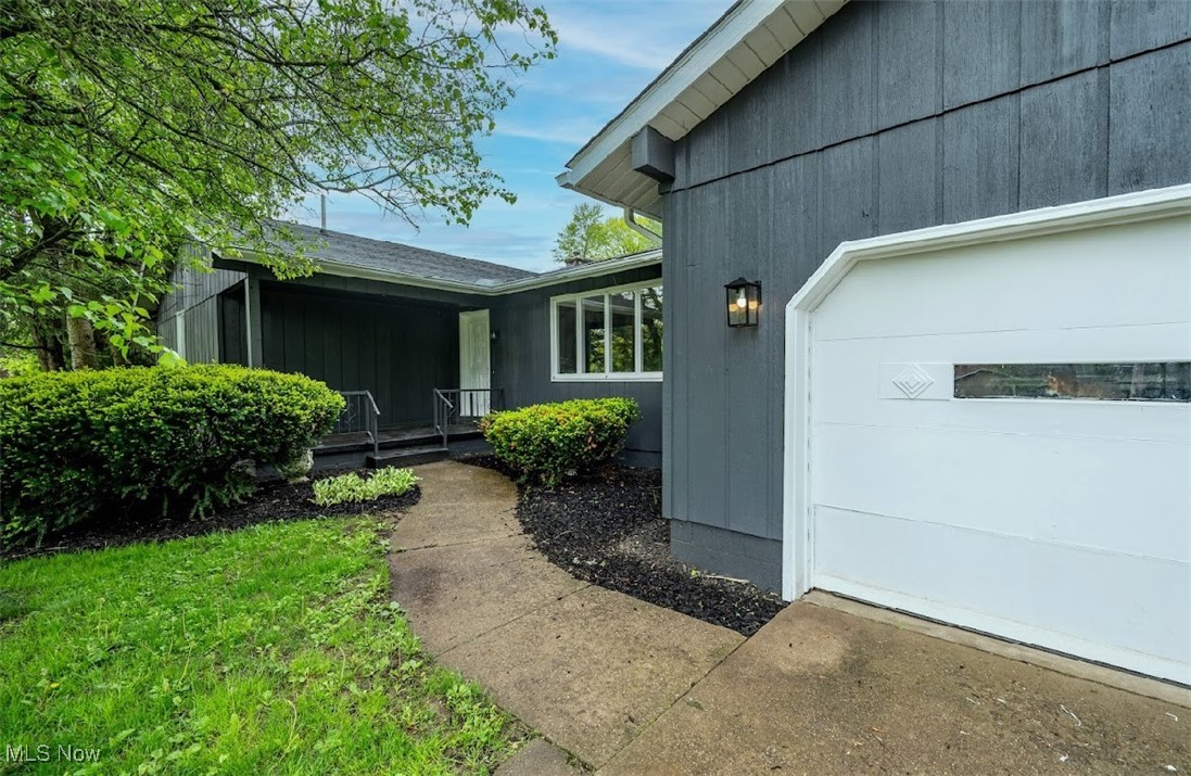 Doorway to property featuring an attached garage