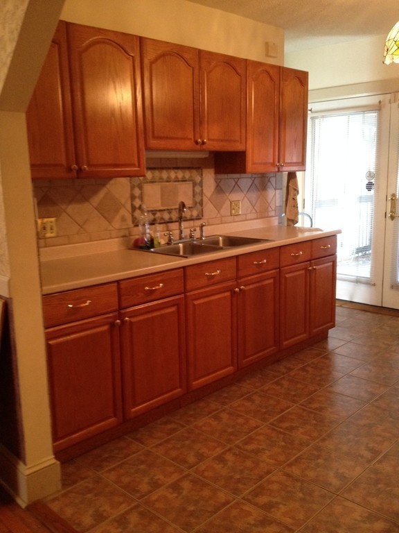 64 Roy Street Springfield, MA 01104 - Photo 12 of 29 a kitchen with granite countertop a sink and cabinets