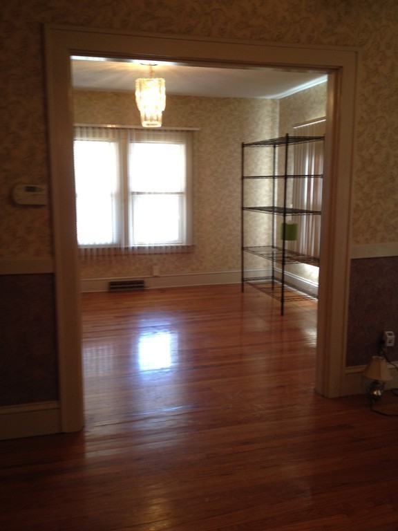 64 Roy Street Springfield, MA 01104 - Photo 6 of 29 a view of empty room with wooden floor and fan