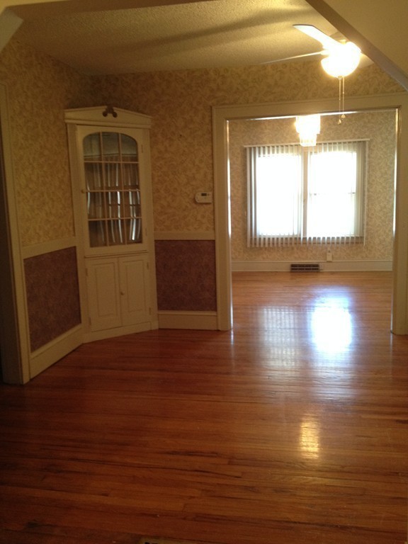64 Roy Street Springfield, MA 01104 - Photo 8 of 29 a view of a room with wooden floor and a window