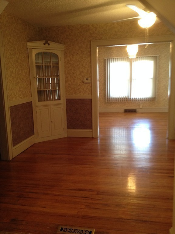 64 Roy Street Springfield, MA 01104 - Photo 9 of 29 a view of empty room with wooden floor and fan
