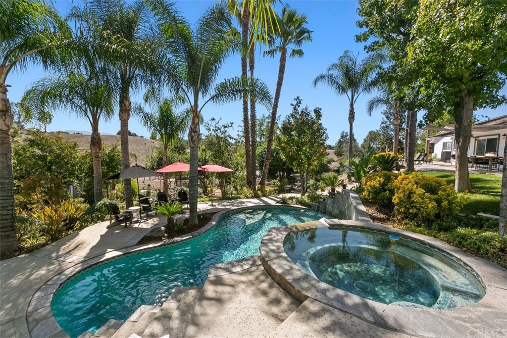 40702 La Colima Road Temecula, CA 92591 - Photo 1 of 1 a view of a house with swimming pool and sitting area