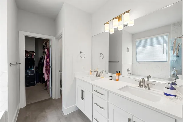 a bathroom with a sink double vanity and a mirror