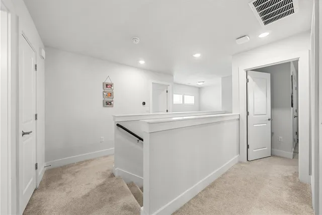 a view of a hallway to kitchen and an entryway