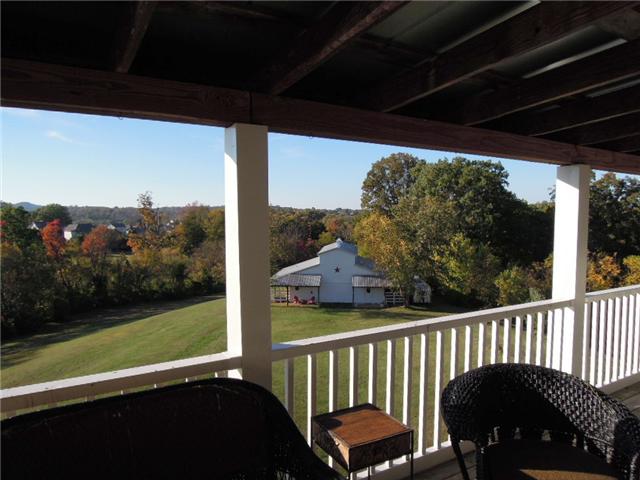 5923 Pettus Road Antioch, TN 37013 - Photo 15 of 20 View from upper deck looking over the 3.5 acres to the barn and beyond. Great views from all three levels of decking. Upper deck is covered as well. Tin roofing.