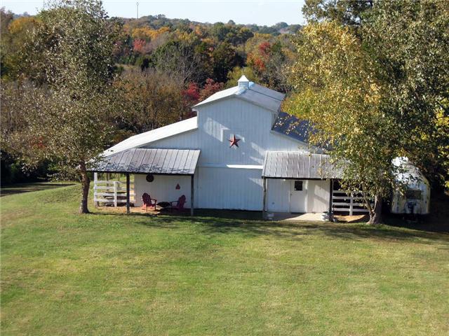 5923 Pettus Road Antioch, TN 37013 - Photo 19 of 20 Wood barn with sliding stall doors and hay loft. Tack room. Awesome for horses or to make office/business studio. Perc test for 2 BR studio at barn. Small storage barn behind this barn.